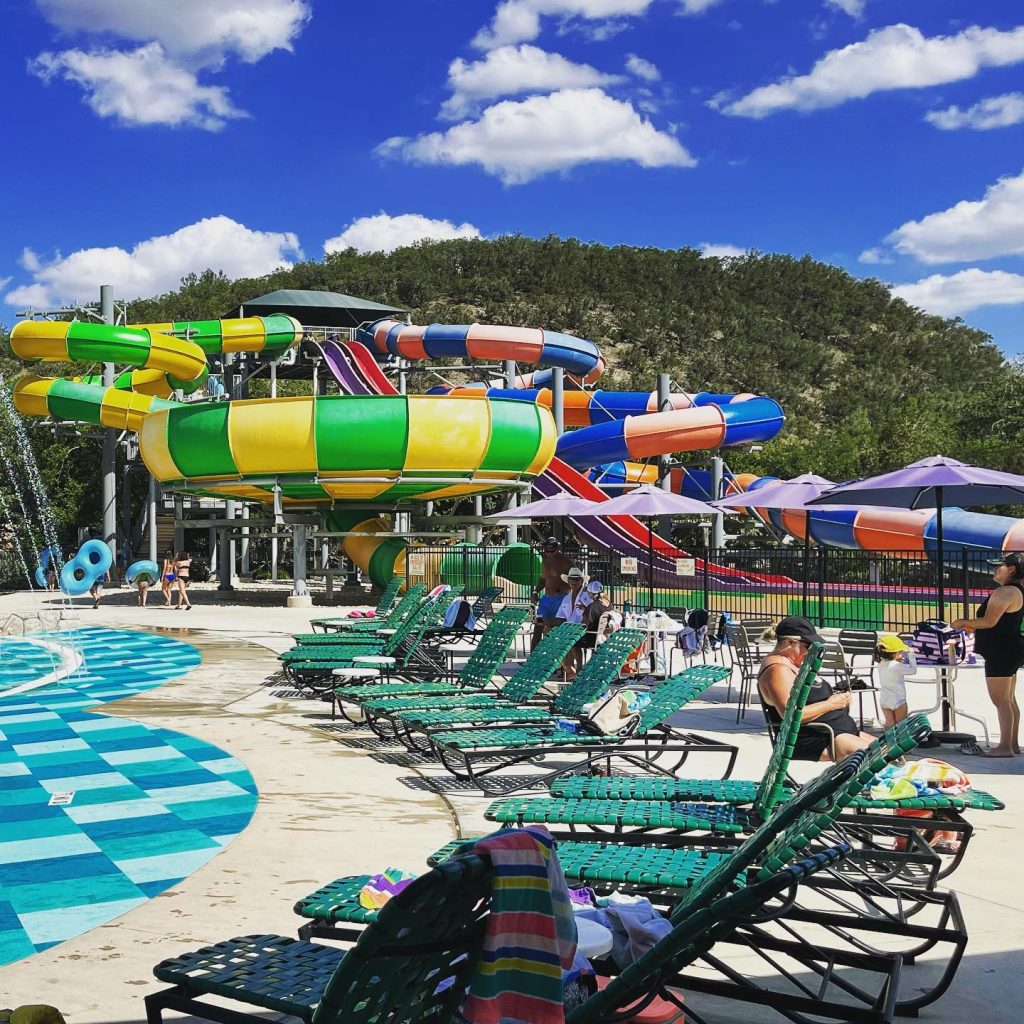 Plan your summer getaway at Camp Fimfo, where cabin and RV camping meet resort-style fun with water slides, a swimming pool, and miniature golf for the whole family. Credit: @inandaroundnbtx via Instagram