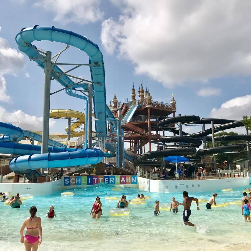 Summer crowds cooling off in the pool at Schlitterbahn, with the iconic castle and towering slides overhead. Credit: Lisa Peek via Facebook