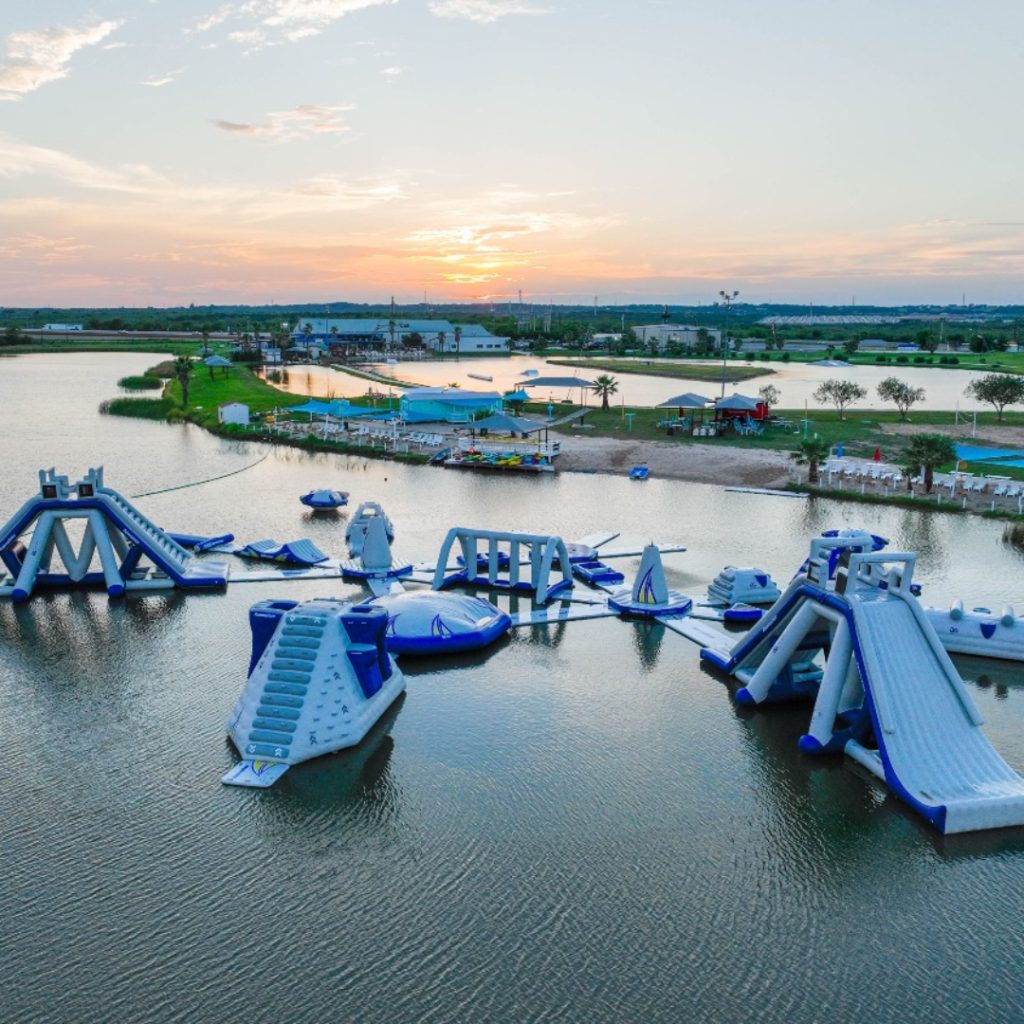 Make a splash at Texas Ski Ranch’s floating aqua park, where endless fun on slides, trampolines, and obstacle courses awaits on the water. Credit: @visitnbtx via Instagram