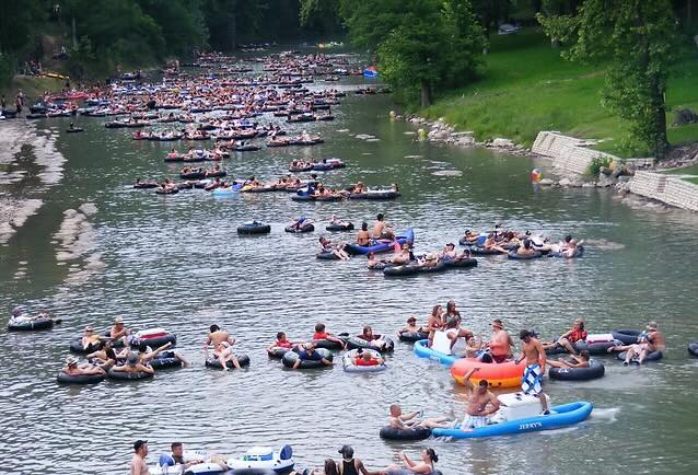 Tubers drift down the Guadalupe River on a sunny Texas afternoon—cool water, good company, and the perfect way to beat the heat. Credit: Tubing the Guadalupe River via Facebook