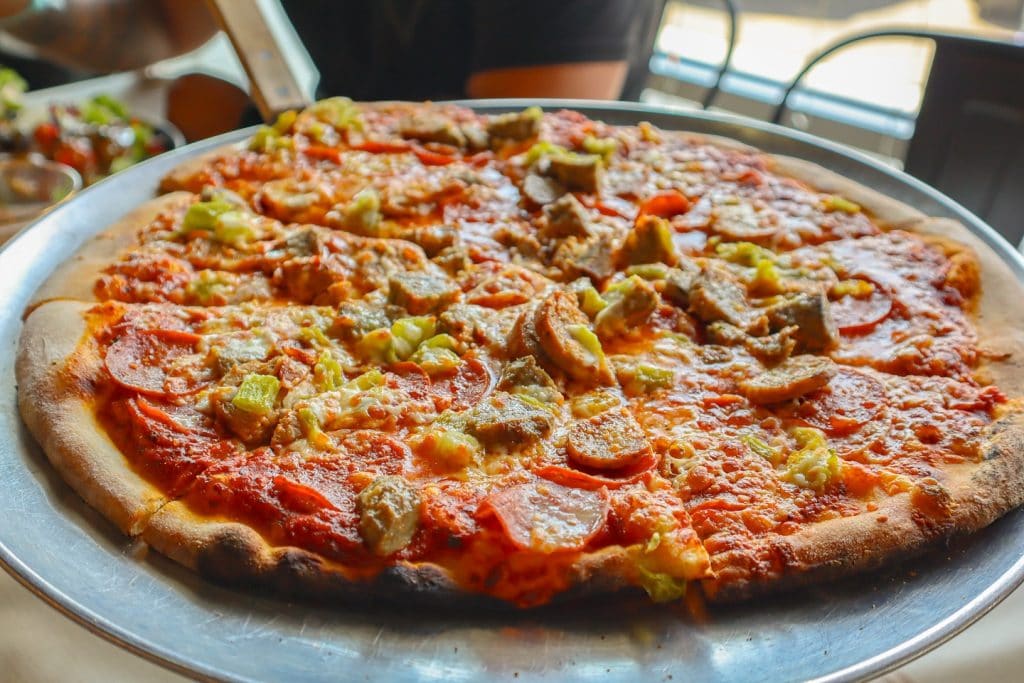 One of the wood-fired pizzas from Above Ground Pizza, baked to perfection with a crisp, bubbly crust. Credit: @abovegroundpizza via Instagram