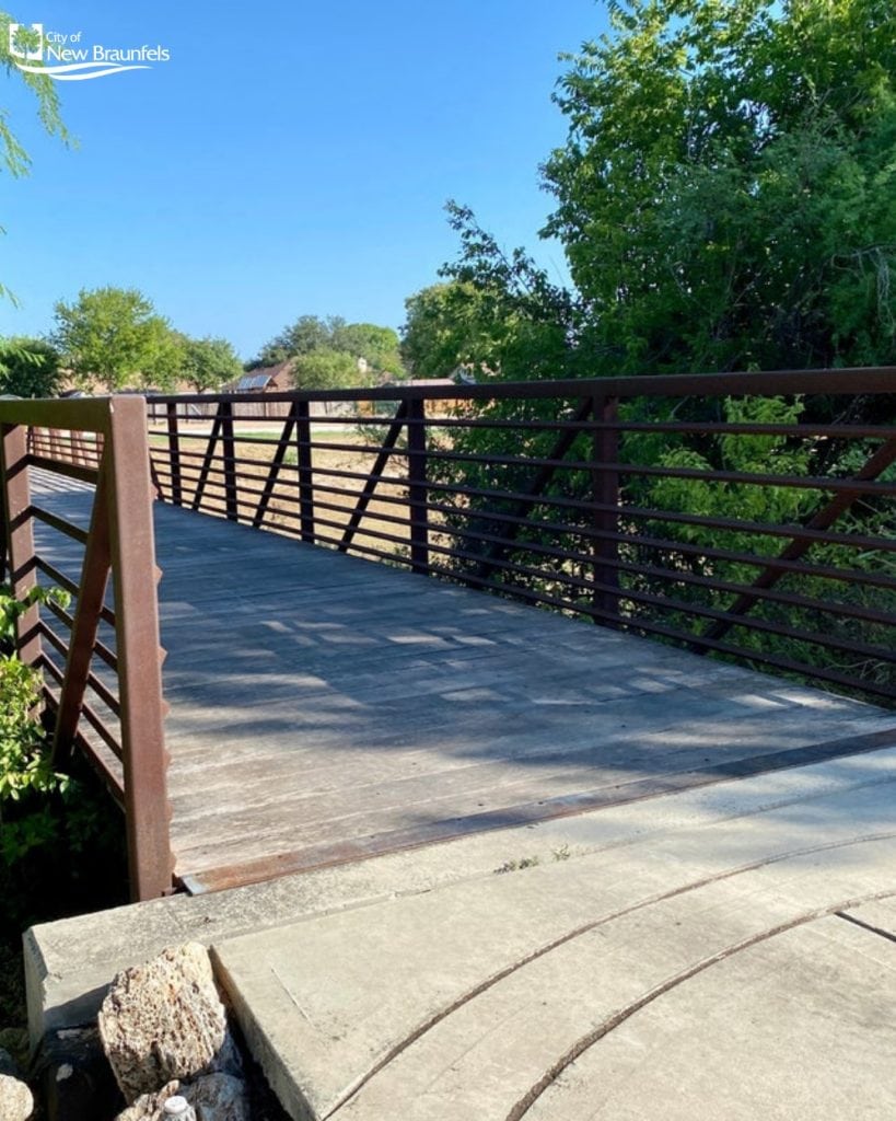 Crossing a scenic bridge along the Alligator Creek Trail, adding charm to your hiking adventure. Credit: @nbparksandrec via Instagram