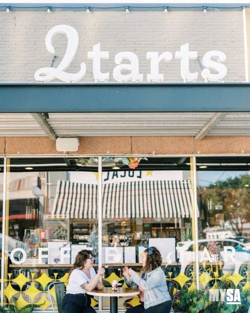 The welcoming facade of 2Tarts Bakery, with the sister owners enjoying a moment at their outdoor table. Credit: @mysanantonio via Instagram