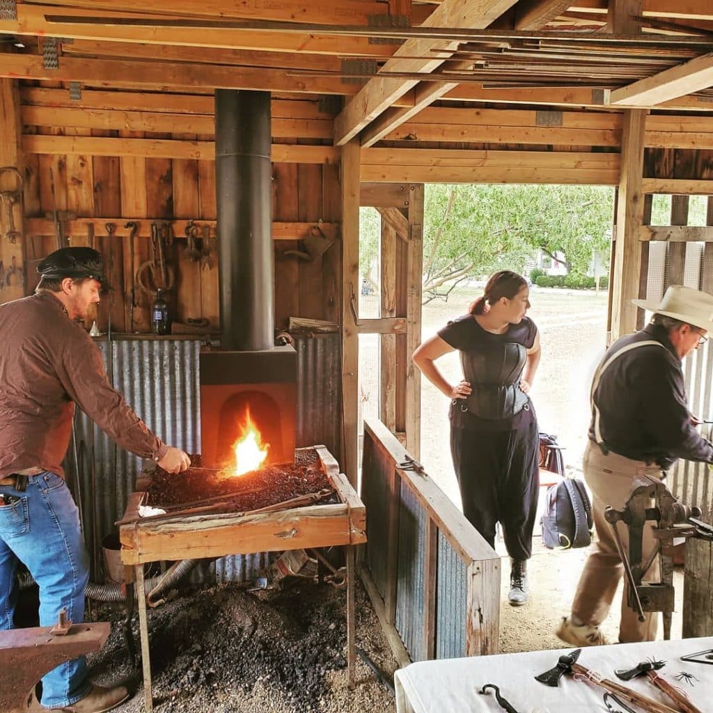 An outdoor workshop at the Museum of Texas Handmade Furniture, where historic skills like blacksmithing and carpentry come to life. Credit: @heritagevillagenb via Instagram