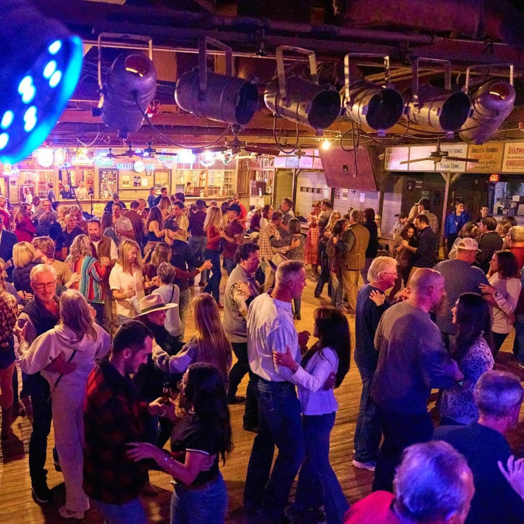 Couples join the Two Ton dance class at Gruene Hall, perfect for beginners and those polishing wraps, turns, and spins. Credit: @gruenehall via Instagram
