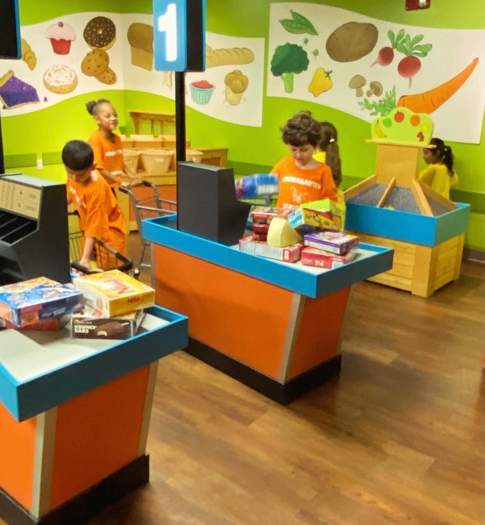Kids diving into imaginative play at the Grocery Store exhibit in the McKenna Children’s Museum. Credit: @mckennakids via Instagram