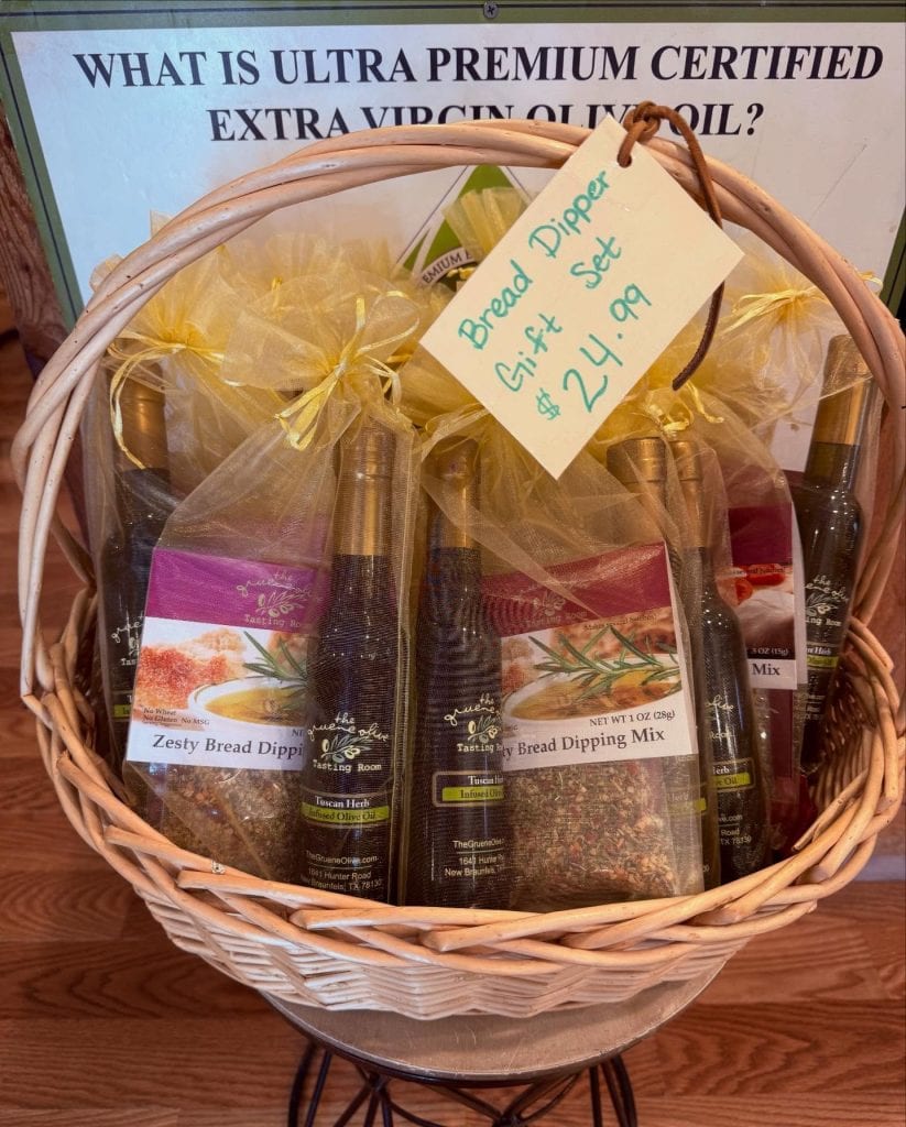 A curated gift basket from The Gruene Olive Tasting Room, filled with favorites like olive oil, balsamic vinegar, and artisan mixes. Credit: @thegrueneolive via Instagram