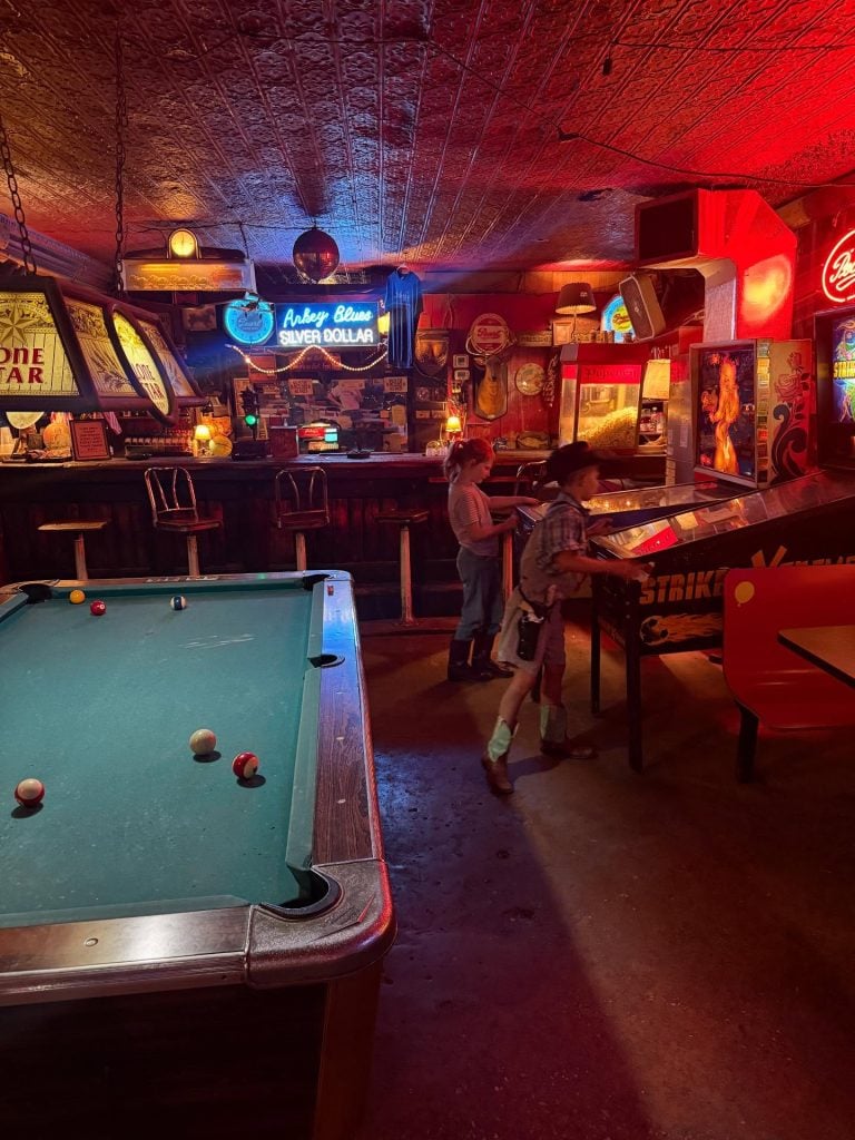 Inside Arkey Blue’s Silver Dollar, the retro honky-tonk décor, wood floors, and neon-lit bar capture a timeless slice of Texas music culture. Credit: @jessecoulter via Instagram