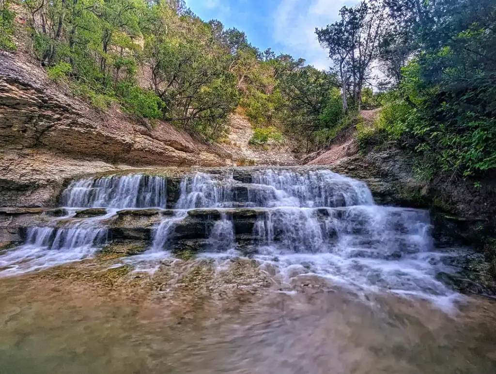 Chalk Ridge Falls Park, just a short drive from Salado, offers scenic trails and hidden waterfalls. Credit: u/AdventuresWithBG via r/TXoutdoors