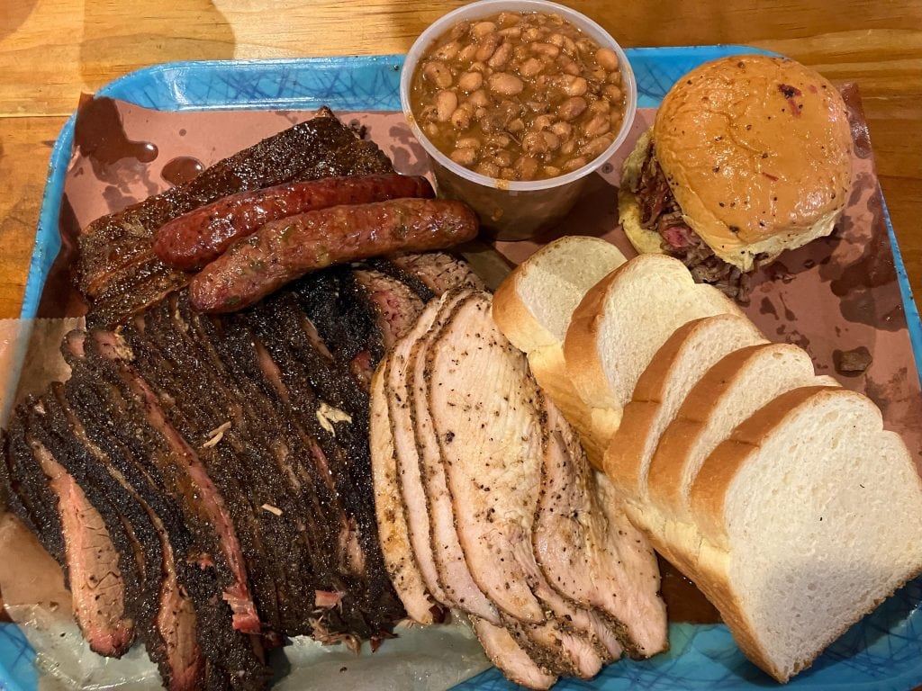 A legendary spread from Franklin’s BBQ—brisket, pork, sausage, beans, and bread. Credit: u/Snoop1341 via r/BBQ
