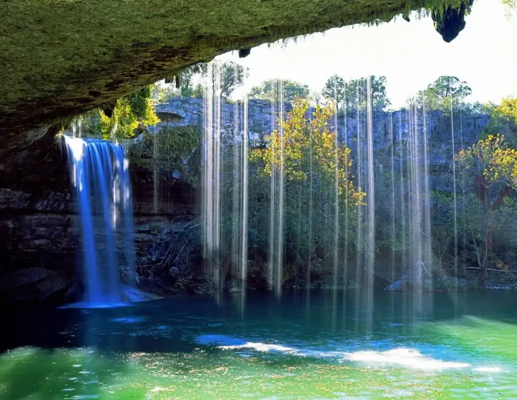 At Hamilton Pool, cascading waters tumble into a jade-green basin framed by eroded cliffs, creating a surreal and enchanting landscape in the Texas Hill Country. Credit: Reddit user via r/pics