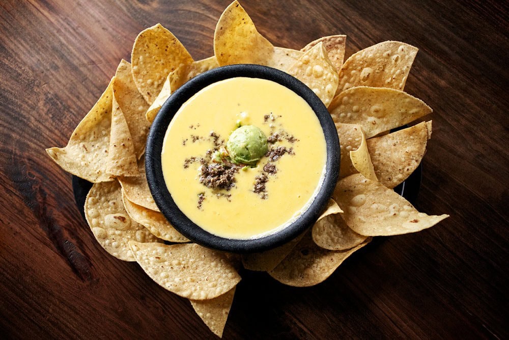 Matt’s El Rancho’s legendary Bob Armstrong Dip — molten queso loaded with taco meat, guac, sour cream, and pico — a must-order for first-timers and regulars alike. Credit: @mattselrancho via Instagram