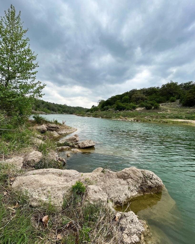 A calm river winds through the scenic landscapes of Milton Reimers Ranch Park, perfect for a quiet afternoon outdoors. Credit: @carolinehealy via Instagram