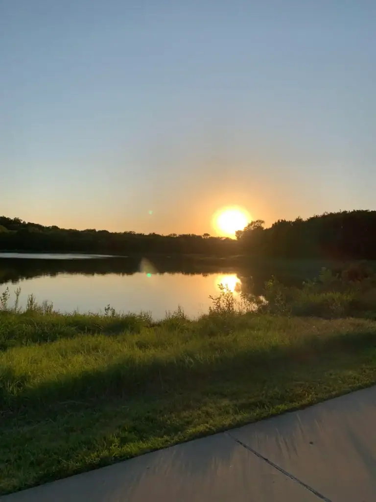 Sunrise at Oak Point Park in Plano paints the sky in soft pastels, with quiet trails and calm water welcoming the day. Credit: u/quinjet83 via r/plano