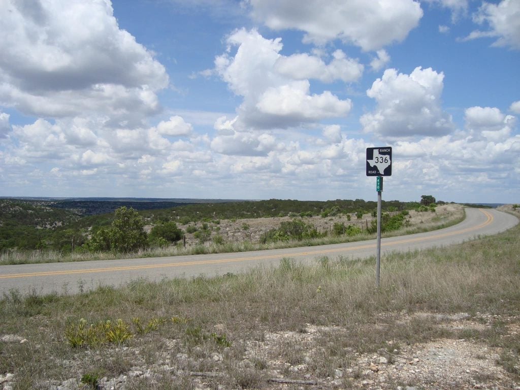 Ranch Road 336 winds through rugged limestone hills and wide-open vistas—an unforgettable Hill Country drive. Credit: Kevin Combs via Facebook