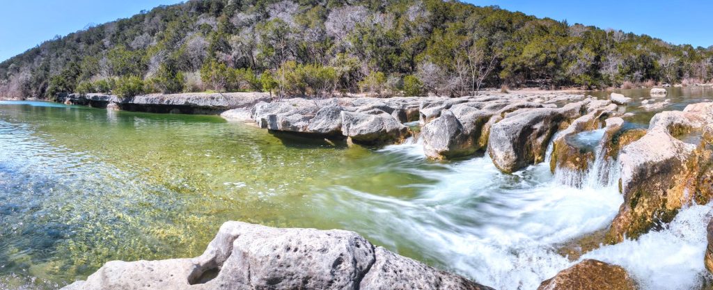 Clear water rushing over limestone at Sculpture Falls. Credit: u/delugetheory via r/Austin