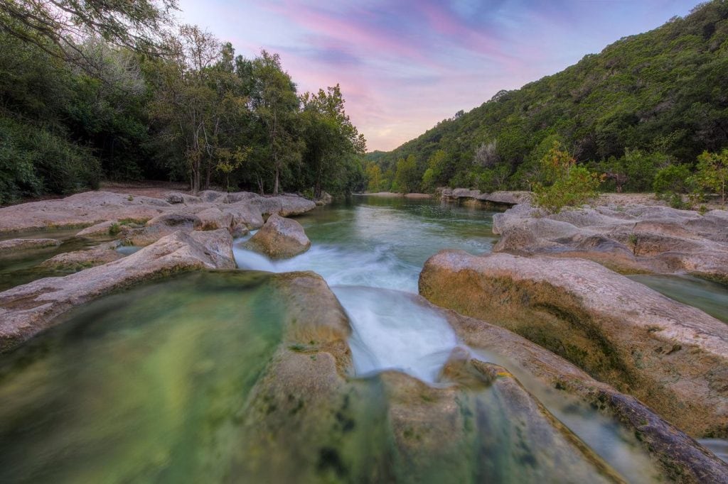 A tranquil view of Sculpture Falls, nestled in the Barton Creek Greenbelt. Credit: @chellebelle_sellsatx via Instagram