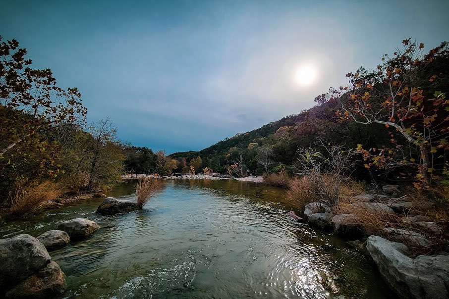 Calm, clear water at Sculpture Falls surrounded by greenery. Credit: @chellebelle_sellsatx via Instagram