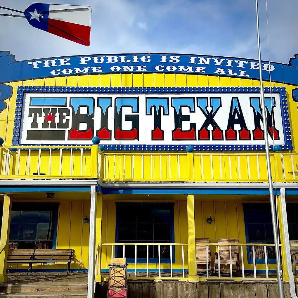 The Big Texan’s bright yellow, blue, and red storefront welcomes everyone with its famous “The public is invited. Come one, come all.” Credit: Reddit user via r/texas