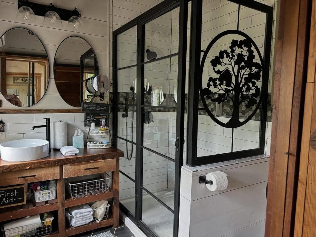 Well-equipped bathroom inside the Air Castle with a full shower, vanity mirrors, fresh towels, and everything you need for a comfortable stay. Credit: @highpointtreehouses via Instagram