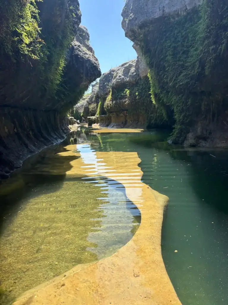 Another angle of the Blanco River Narrows, highlighting the crystal-clear water and massive rock walls rising on each side. Credit: u/19TowerGirl89 via r/CampingandHiking