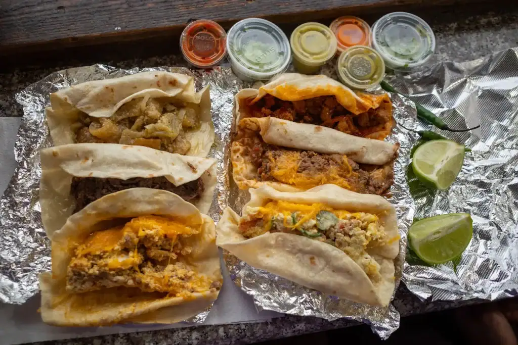 A breakfast taco from Brother’s Taco House, served with lime and an assortment of house salsas — simple, satisfying, and a true Houston morning staple. Credit: Krystal Liu