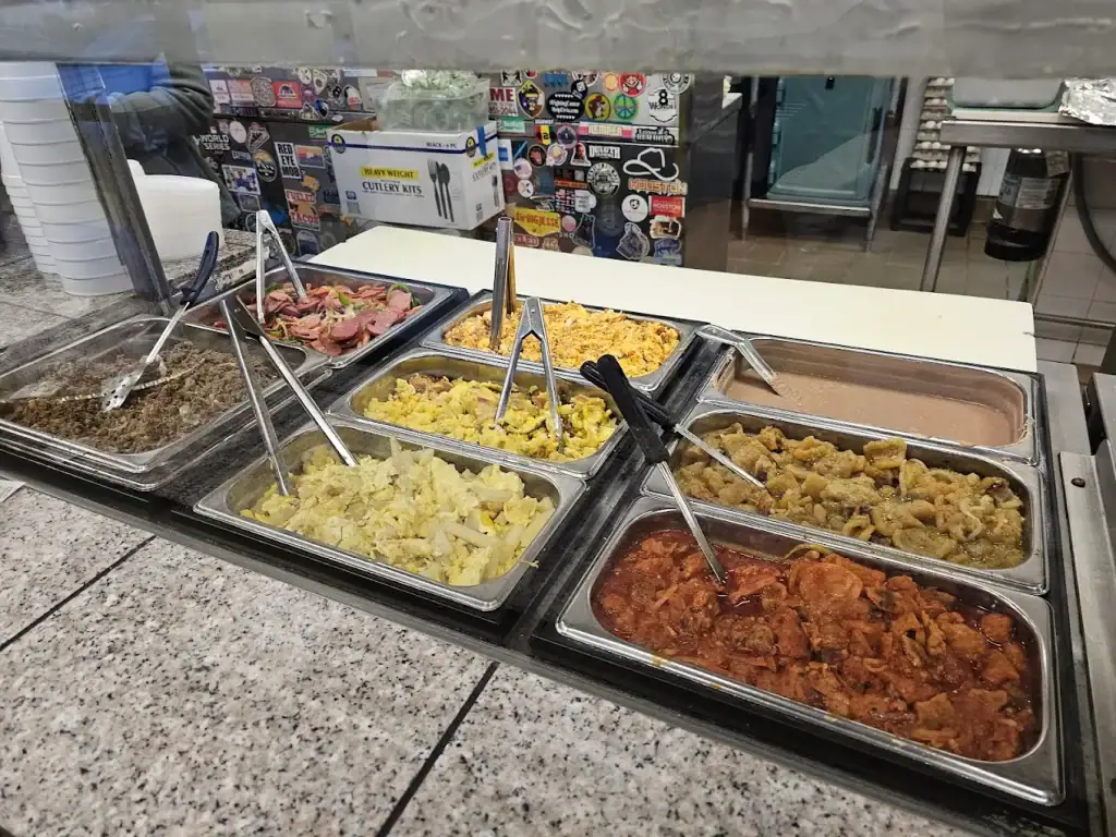 Taco fillings on display at Brother's Taco House — trays of eggs, meats, and sausages ready to be tucked into fresh tortillas for classic Tex-Mex breakfast tacos.  Credit: Warren Marsh Jr
