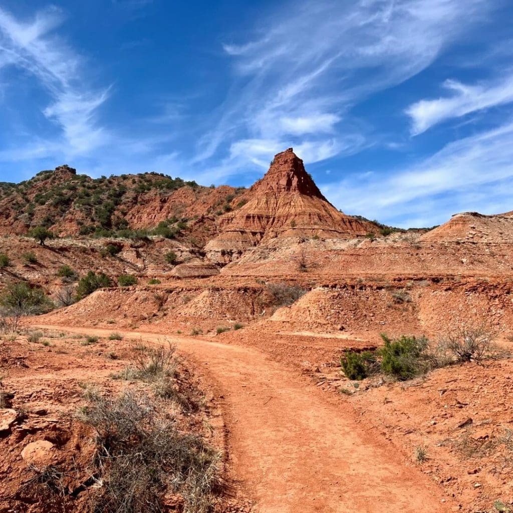 Hiking trails cut through dramatic red rock formations at Caprock Canyons State Park. Every turn feels unreal. Credit: @traveltex via Instagram