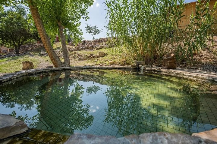 Soak in the natural hot spring tub at Chinati Hot Springs—a desert oasis for ultimate relaxation. Credit: @chinatihotsprings via Instagram