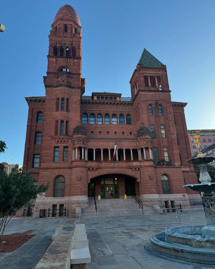 The Bexar County Courthouse was built in Romanesque Revival style and constructed from distinctive reddish-orange sandstone. Credit: @rosiesgfsweets via Instagram