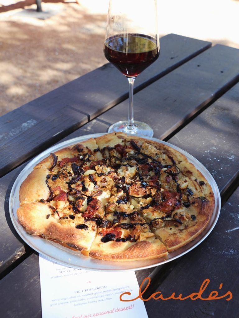 Pizza and wine from Claude’s Restaurant, one of the on-site dining spots at The Lodge at Cypress Falls. No need to leave when hunger hits. Credit: @thelodgeatcypressfalls via Instagram