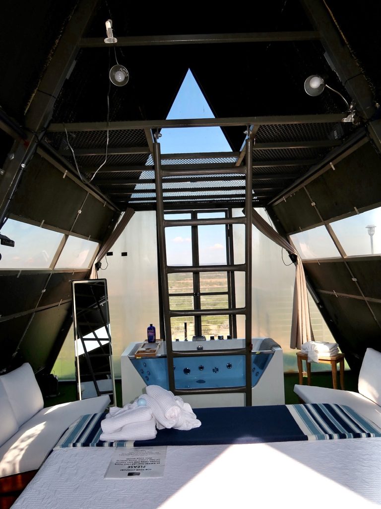 The Wings cabin at The Retreat on the Hill is a convertible A-frame with four 10-foot doors that open like wings—complete with full amenities and an indoor soaking tub. Credit: @theretreatonthehill via Instagram