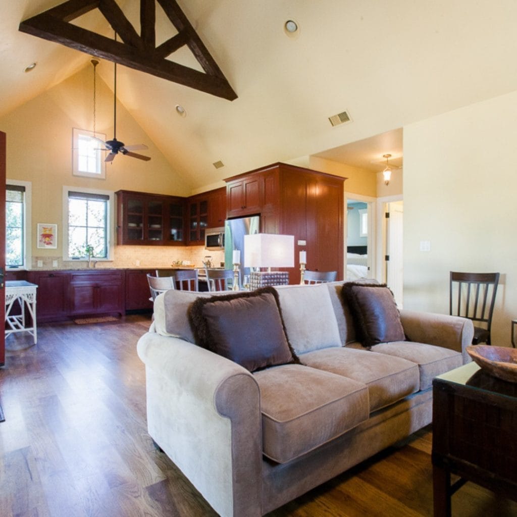A spacious and relaxing interior at Fall Creek Vineyards, designed with neutral tones, wooden furnishings, and complete amenities for a comfortable retreat. Credit: @fallcreekvineyards via Instagram