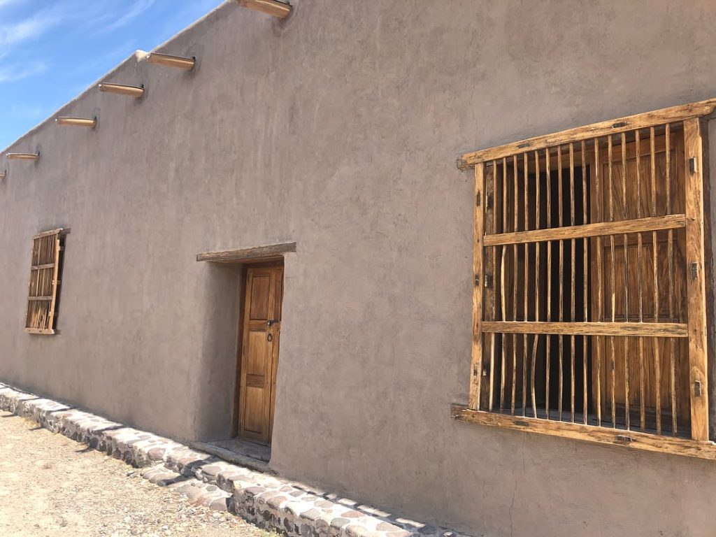 Exterior view of Fort Leaton—classic adobe construction with wooden doors and windows, standing strong against time. Credit: @serenablondie via Instagram