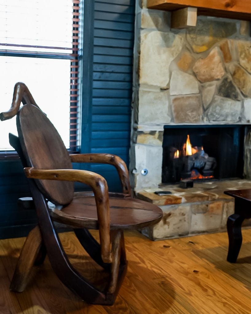 Relaxing inside one of Hideout on the Horseshoe’s cabins, where a fireplace creates the perfect setting to unwind. Credit: @hideoutonthehorseshoe via Instagram