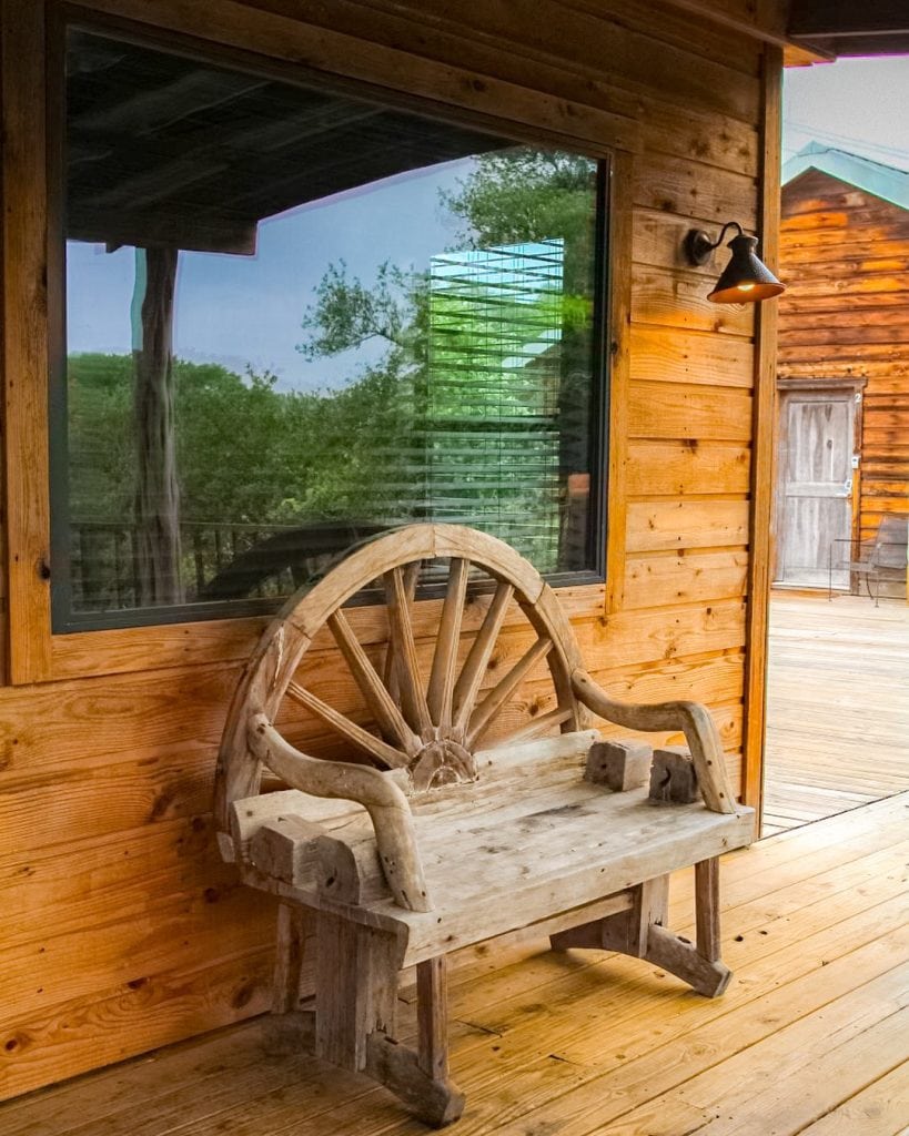 A cozy outdoor seating area at one of the cabins—imagine sipping your morning coffee while gazing out at the Guadalupe River. Pure vacation mode. Credit: @hideoutonthehorseshoe via Instagram