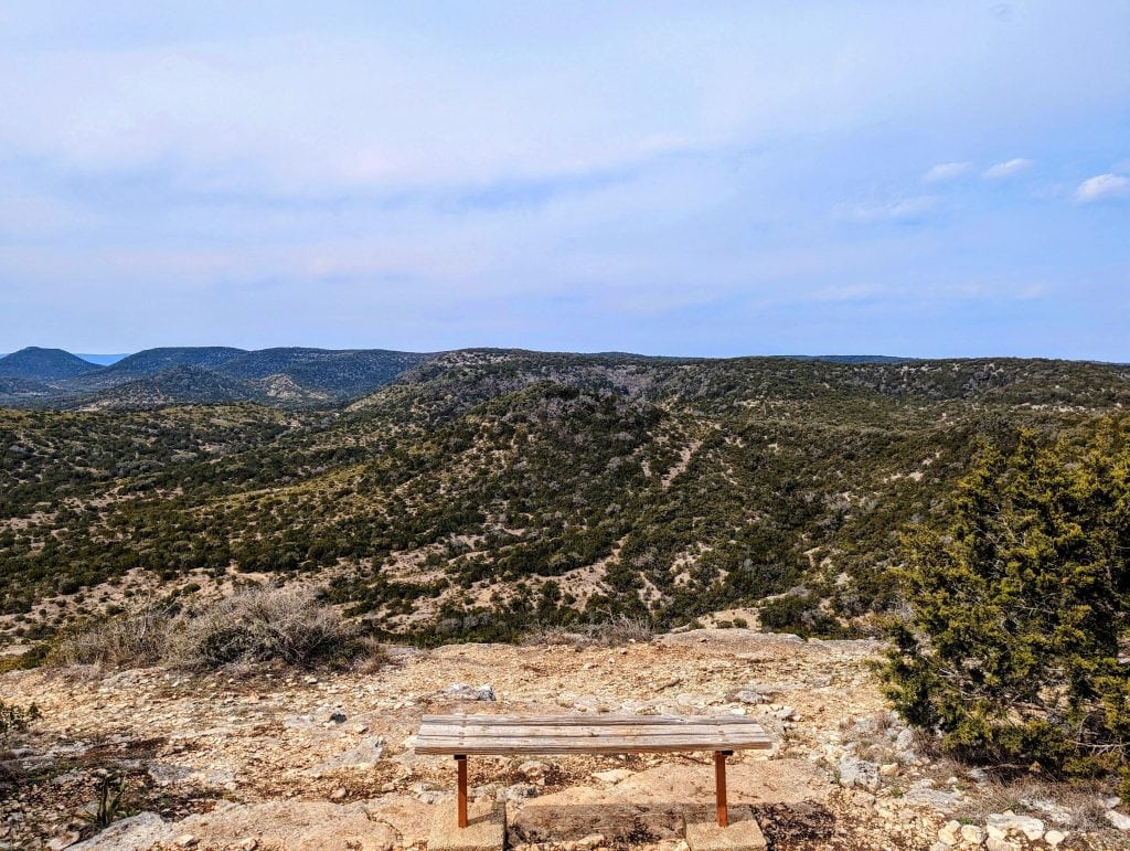 A quiet bench overlooking Hill Country State Natural Area. The perfect spot to pause, breathe, and soak it all in. Credit: u/putamare via r/TXoutdoors