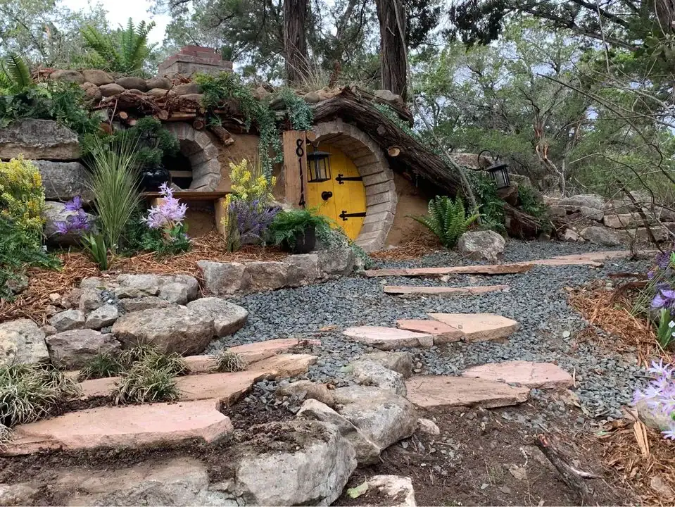 A charming landscaped pathway leading to the Hobbit House—setting the tone for a magical, storybook-like escape. Credit: u/majorvex via r/texas
