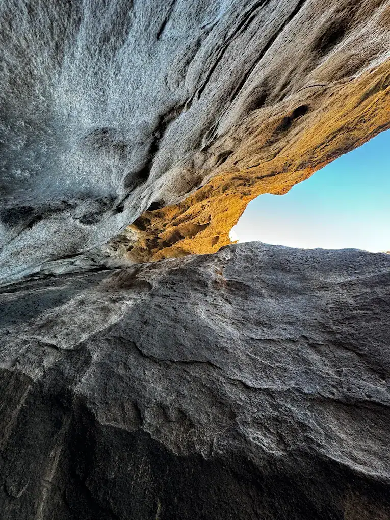A cool view framed between massive rocks shows the thrilling angles climbers experience at Hueco Tanks. Credit: Ronda Stavinoha