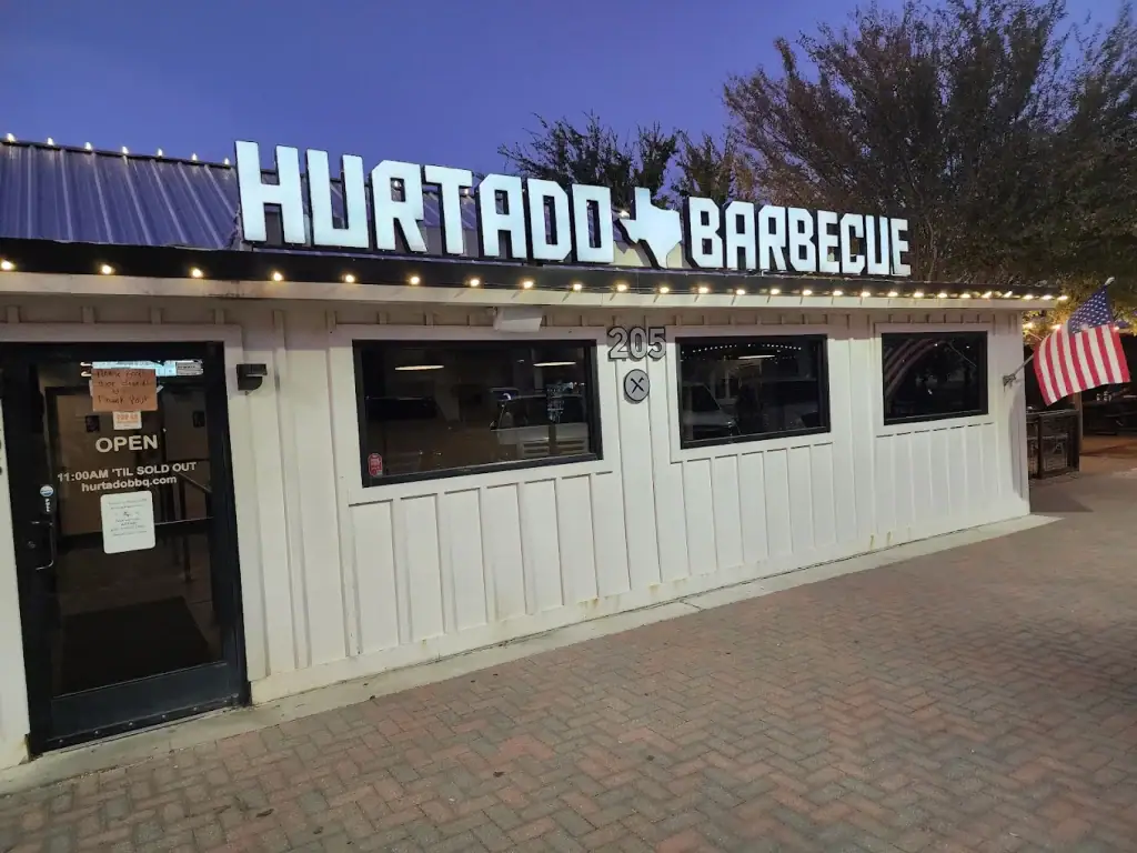 The front storefront of Hurtado Barbecue — home of their famous bacon burnt ends and one of the must-visit Texas BBQ spots. Credit: Marc L.