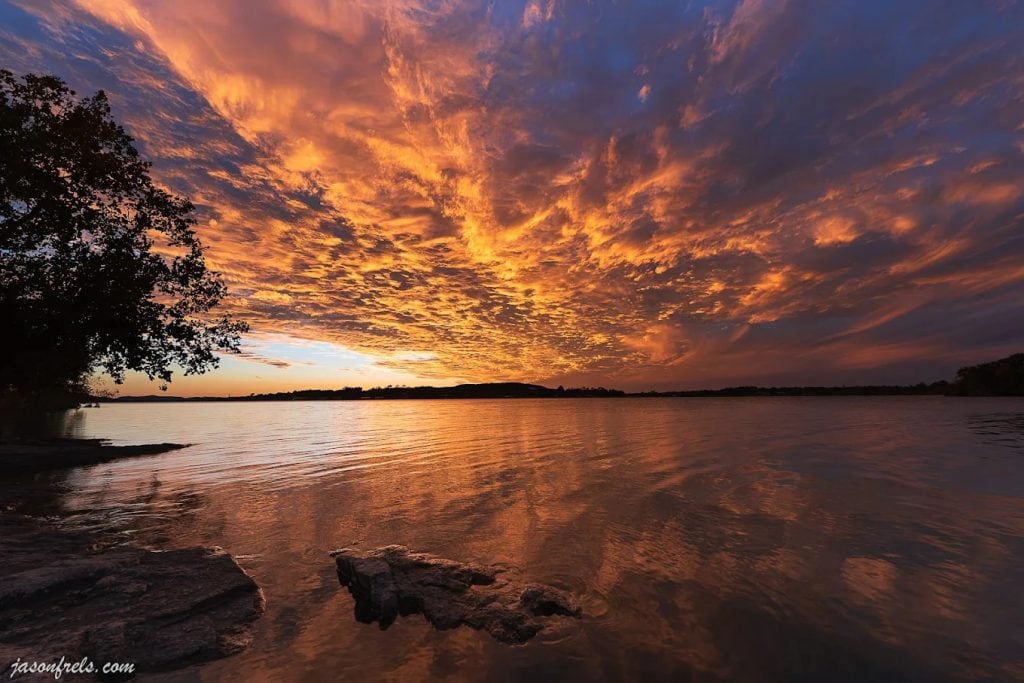 Sunset views at Inks Lake are simply breathtaking, painting the sky in unforgettable colors. Credit: Jason F