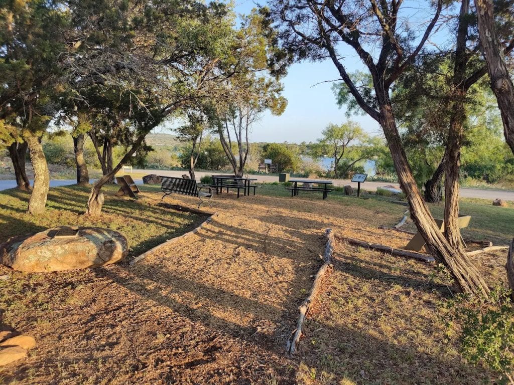 Picnic tables shaded by trees make Inks Lake a relaxing spot for family gatherings and outdoor meals. Credit: Ralph Bissey