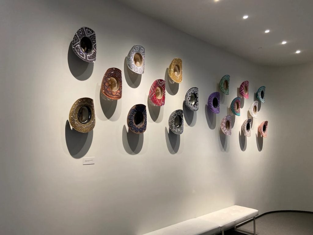 A colorful array of cowgirl hats is on display, each one showcasing unique style and flair. Credit: Julie Gray