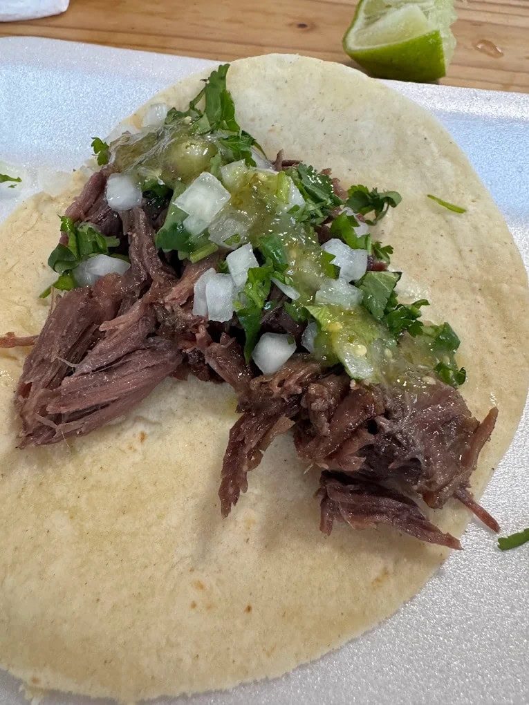 Vera’s barbacoa wrapped in a tortilla, topped with salsa, cilantro, and onions, is the go-to way to enjoy their legendary meats. Credit: Dolf