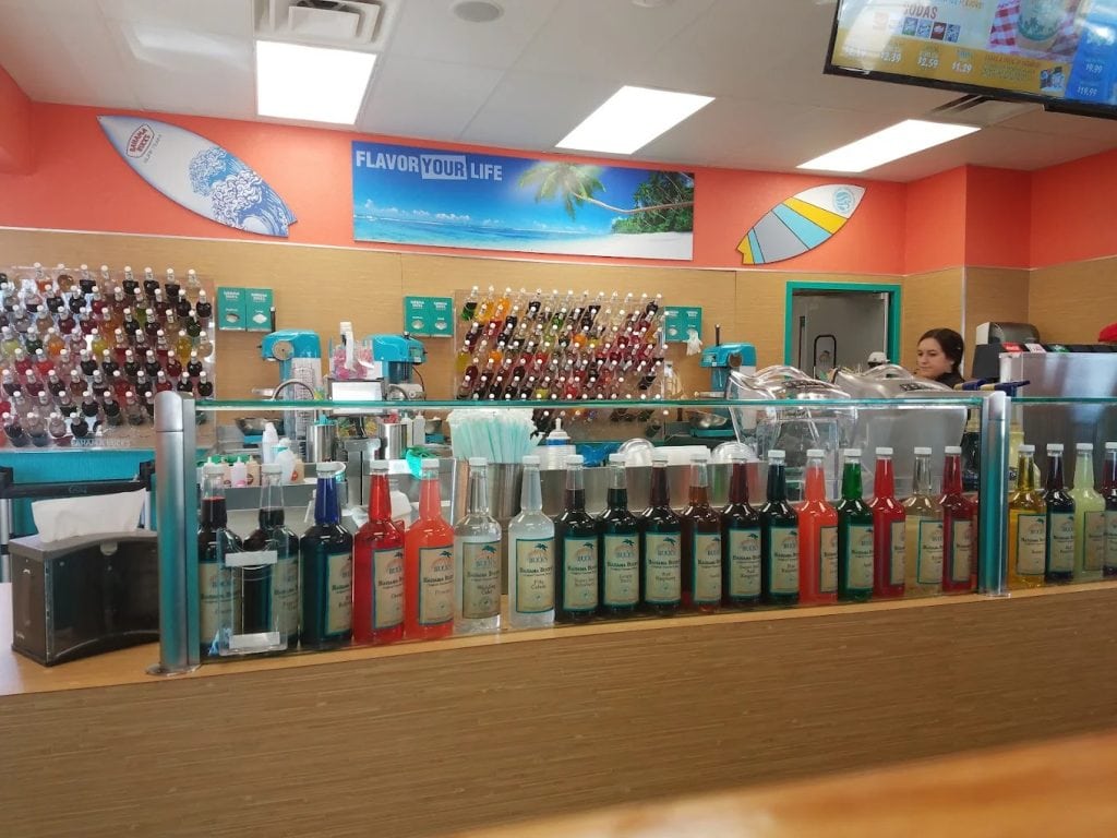 Rows upon rows of flavorings line the counter, highlighting the endless possibilities for shaved ice. Credit: Monty Rodgers