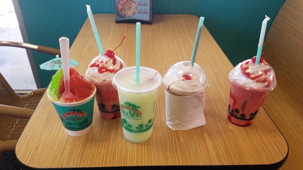 An assortment of shaved ice, drinks, and smoothies—some topped with cherries, whipped cream, or tropical flair—showcases the fun mix of treats. Credit: Tim's Digital Darkroom