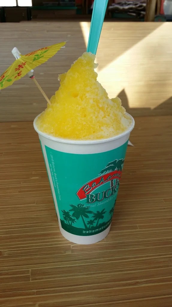 A mango-flavored shaved ice, bright yellow and refreshing, comes complete with a tiny umbrella for that island touch. Credit: William “Willy4u4” Vilaseca