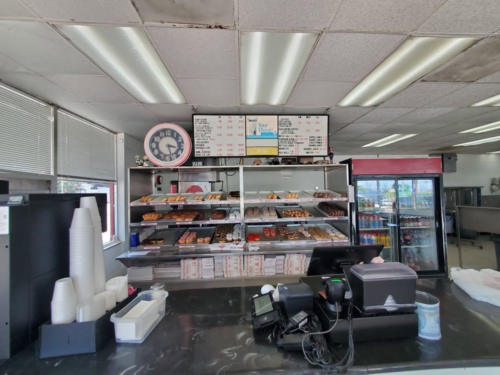 Inside at the counter, an assortment of donuts is displayed, tempting guests with fresh choices. Credit: Troy S.