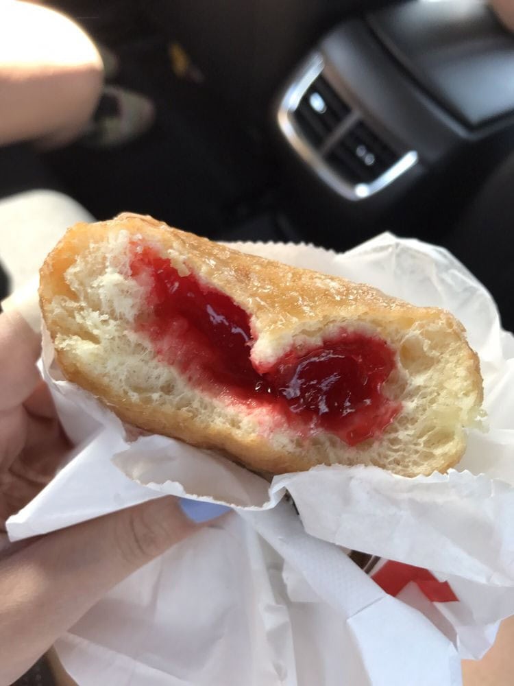A raspberry cream-filled donut showcases soft, fluffy bread with a sweet burst inside. Credit: Kelly Z.