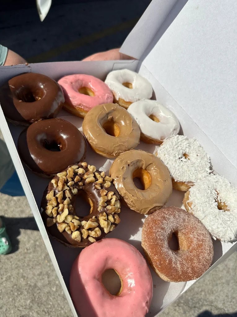 A box of assorted donuts features icing, cream-filled varieties, and cinnamon sugar favorites. Credit: K Stevens